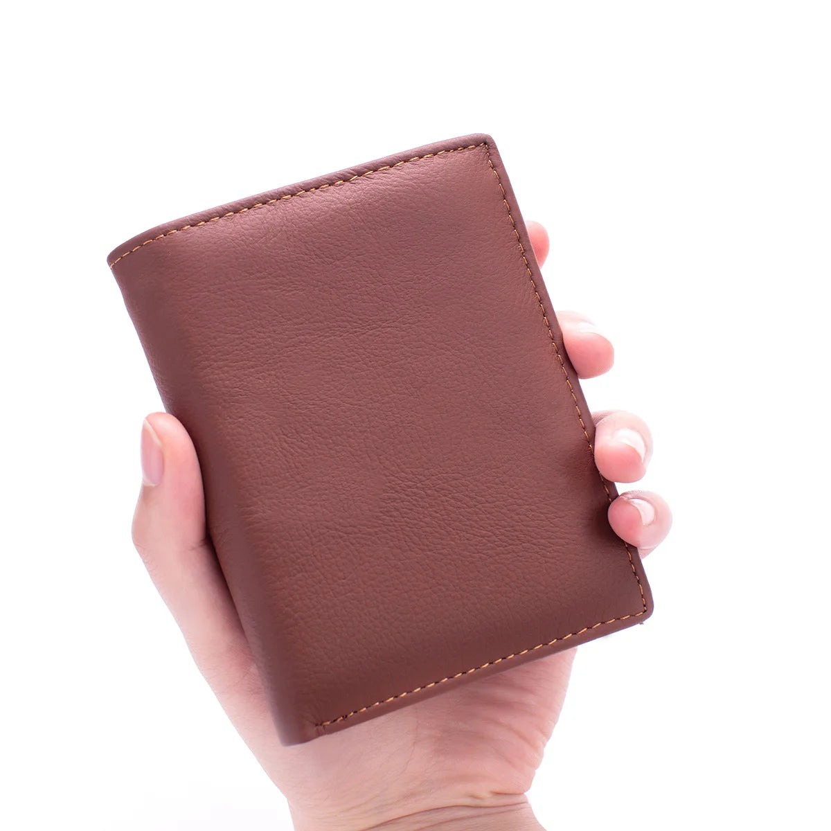 A hand holds a brown genuine leather men's business wallet with a stitched edge.