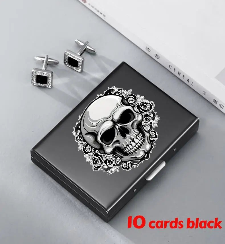 A black slim card holder wallet featuring a silver skull design surrounded by floral elements.