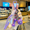 A hand holds a purple D-shape nylon fitness keychain with a heart charm and a 200 weight marker.