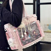 A pink transparent shoulder tote bag featuring a collage of anime characters and decorative strings.