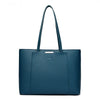 A dark blue leather shoulder bag with a handle is shown against a white background.
