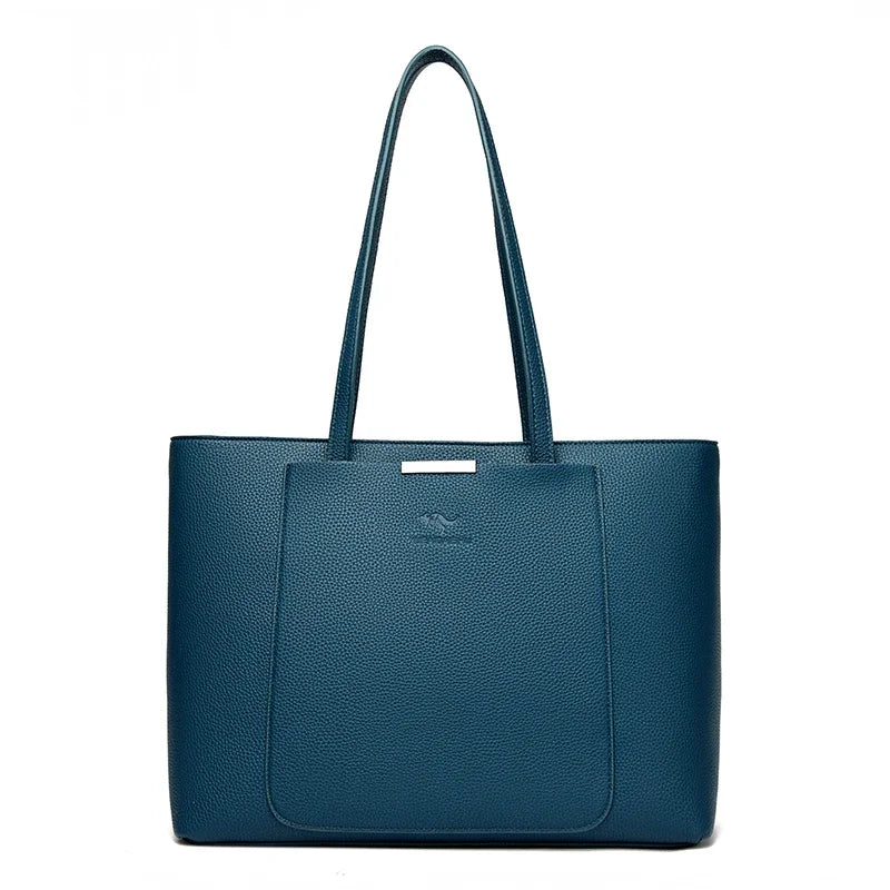 A dark blue leather shoulder bag with a handle is shown against a white background.