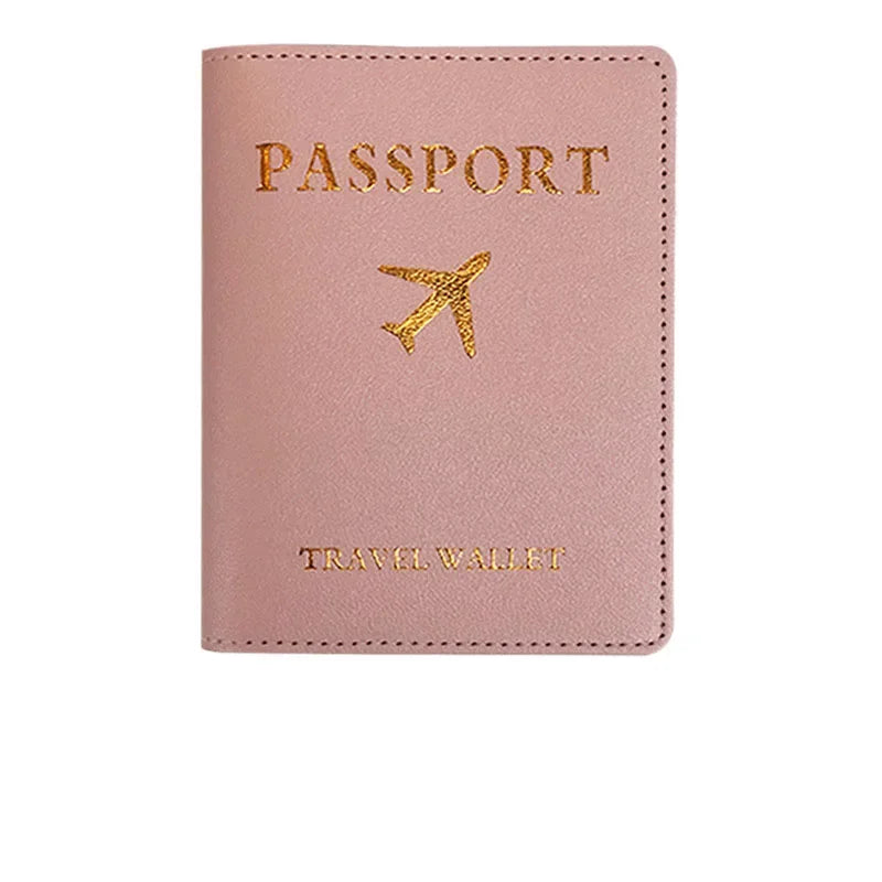 A pink PU leather passport holder with gold foil printing of an airplane and the words Passport and Travel Wallet.