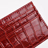 A close-up of a reddish-brown crocodile embossed slim PU leather card holder wallet.