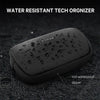 A black water resistant tech organizer pouch with a zipper is shown on a dark surface.