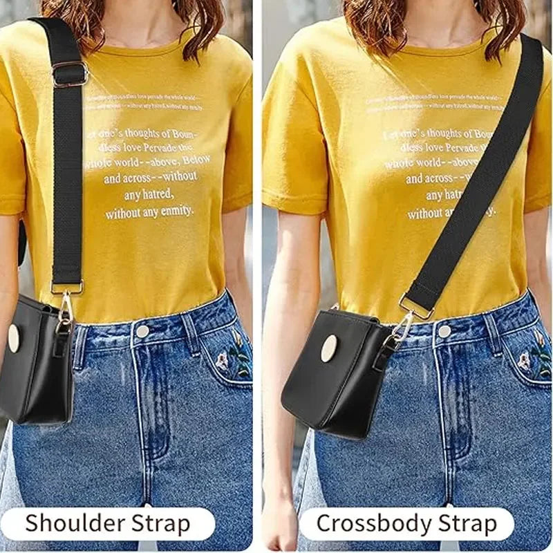 A woman models a black leather crossbody strap attached to a small black bag against a yellow t-shirt and denim jeans.