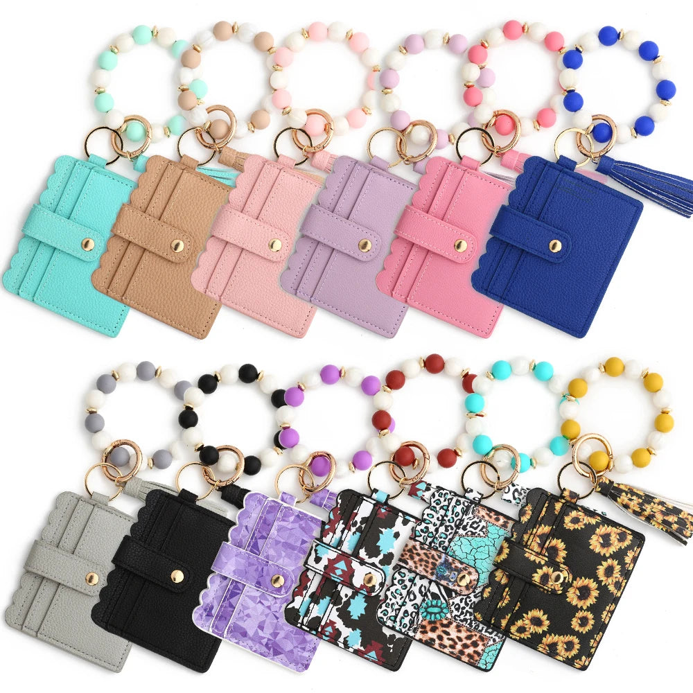 A collection of silicone bead and leather card wallets in various colors and patterns.