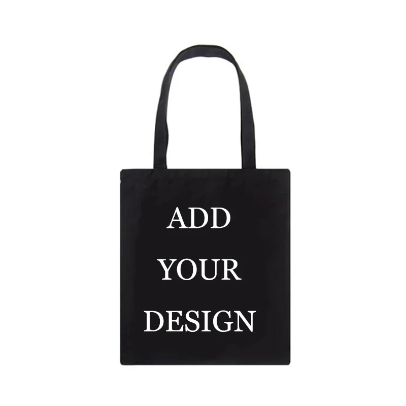 Sac de courses en toile noire avec du texte blanc indiquant 'Ajoutez votre design'