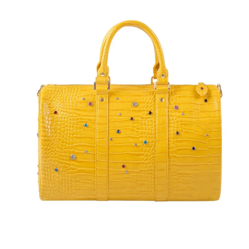 A bright yellow faux crocodile leather tote bag with crystal accents.