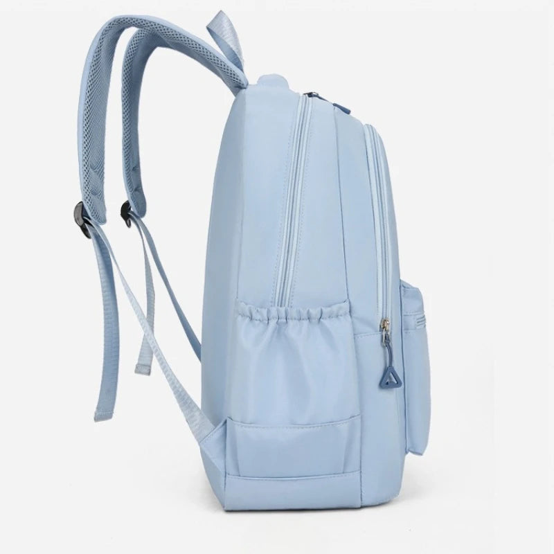 A light blue durable nylon commuter backpack shown from the side.