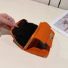 An orange multi-slot card holder is shown open on a light surface.