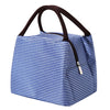 A blue and white striped insulated lunch tote bag with a black adjustable shoulder strap.