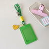 A green PU credit card and ID holder is attached to a keychain with a pink plastic card holder.