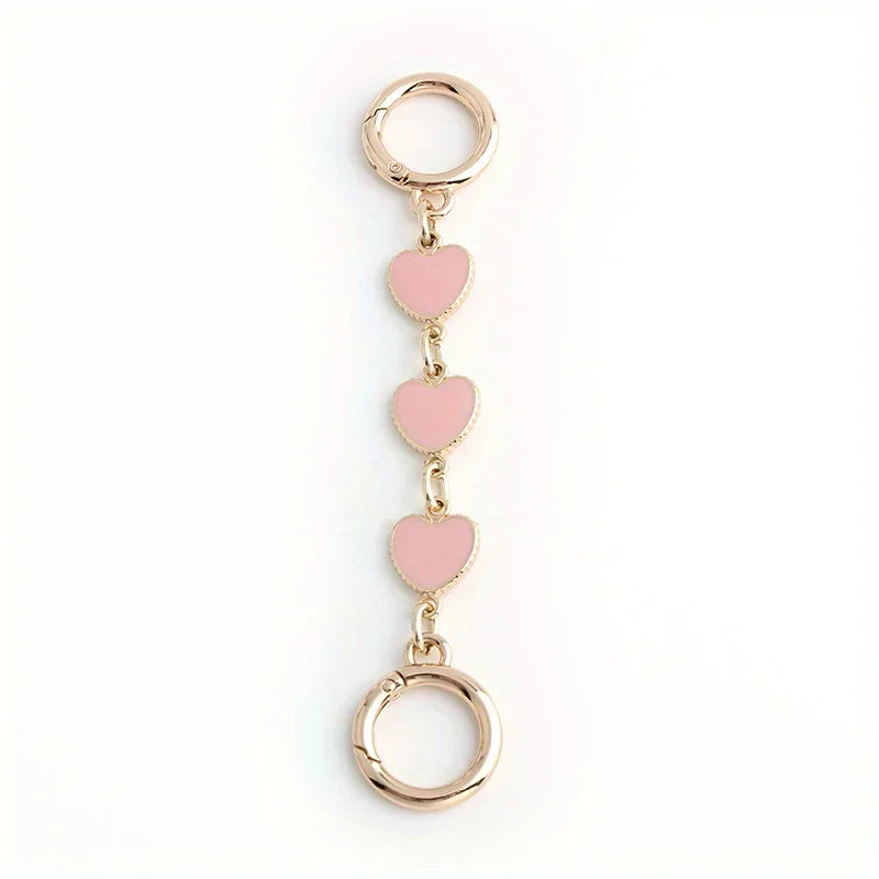 Gold-toned metal chain shoulder strap extension with a heart pendant for handbags