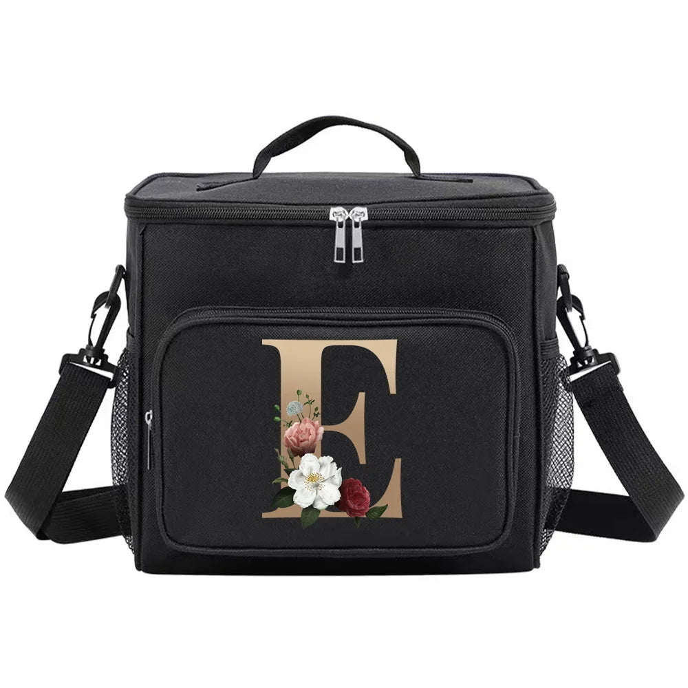 Black insulated canvas lunch bag with dual handles featuring a gold initial and floral design.