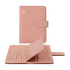 A pink PU leather passport holder with credit card slots shown in a flat lay view.