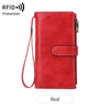 A red leather trifold clutch wallet with a protective RFID shield and attached lanyard.