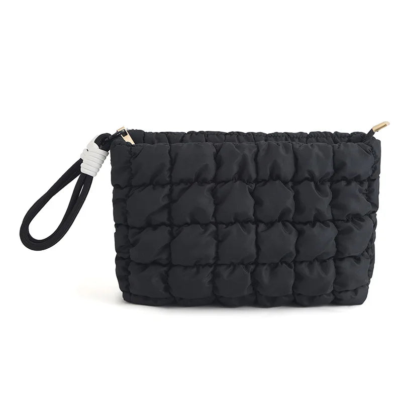 Black quilted puffer makeup bag with a white strap