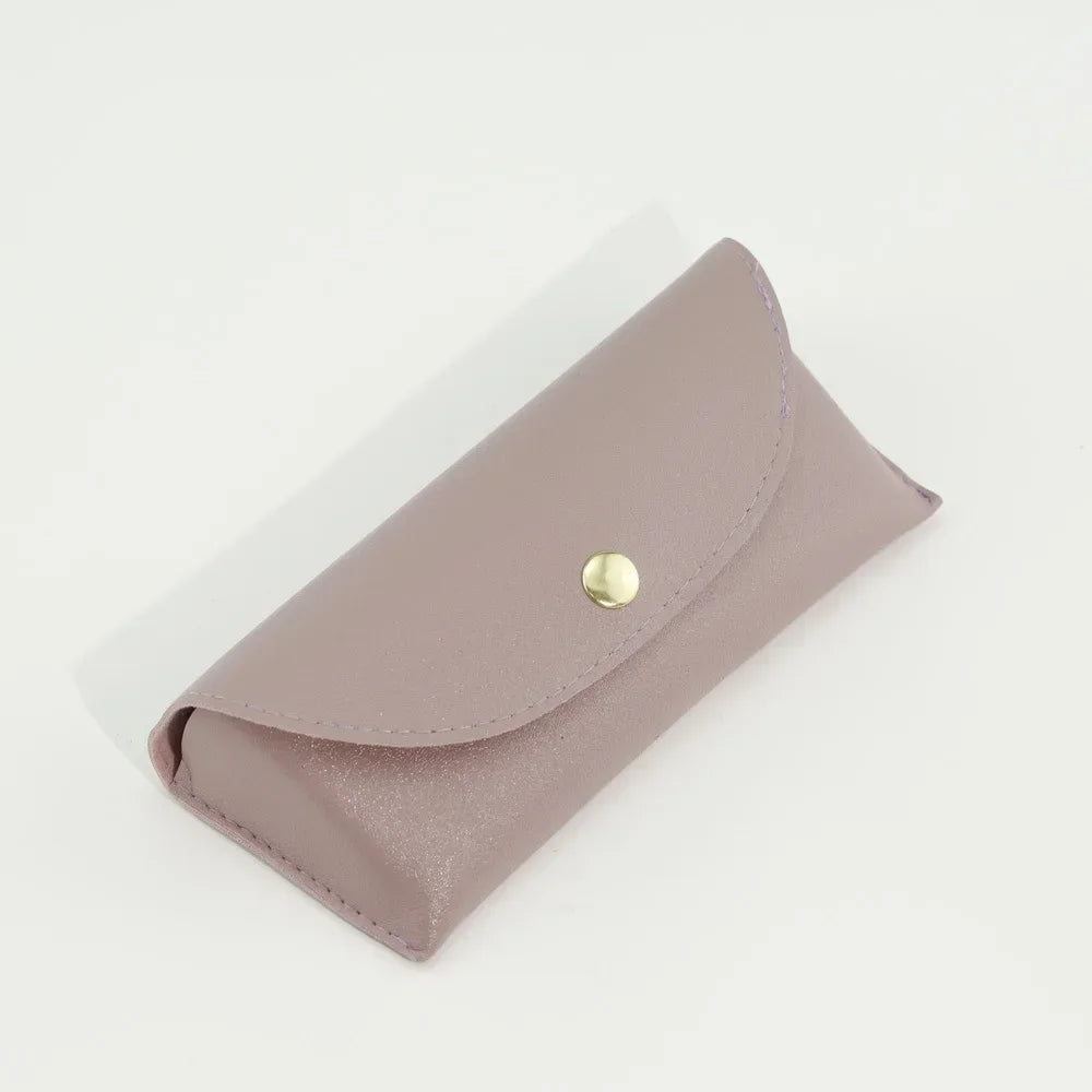 A soft mauve PU leather hard shell sunglasses case lying on a white surface.