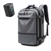 A gray heavy duty laptop backpack with vacuum compression features is shown next to its detached battery unit.