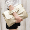 A person holds an elegant sequined crossbody clutch bag in a champagne gold color.