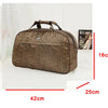 A brown PU leather travel duffel bag with a patterned design shown next to a ruler for scale.