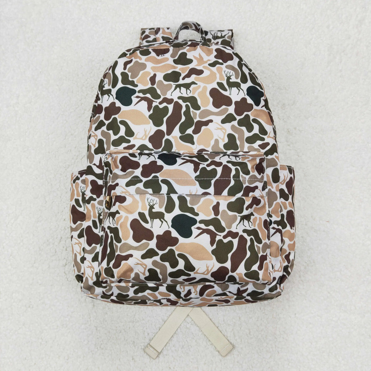 A camouflage backpack featuring brown, green, and tan animal prints on a white background.