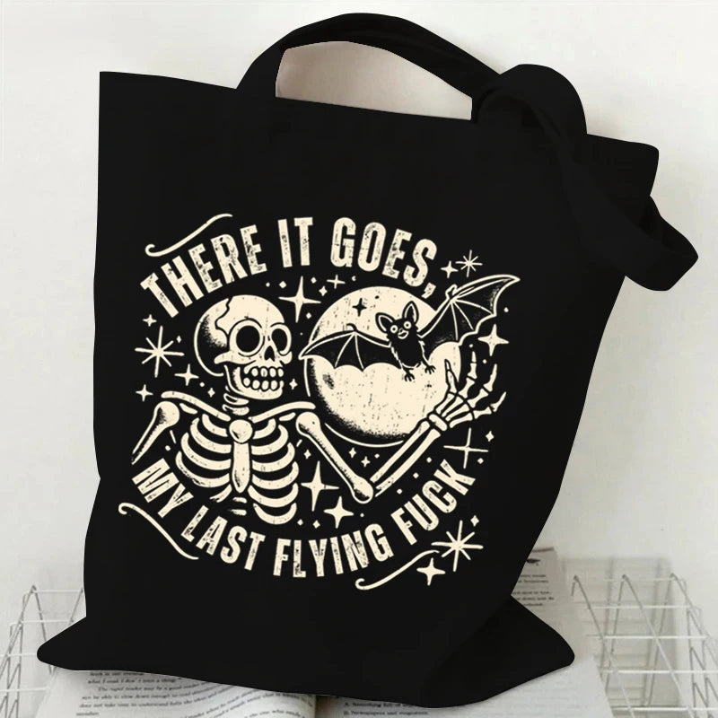 Black canvas tote bag featuring a distressed graphic of a skull and bat with text.
