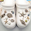 Pair of white shoe charms featuring starfish, shells, and pearls for ocean beach themed footwear
