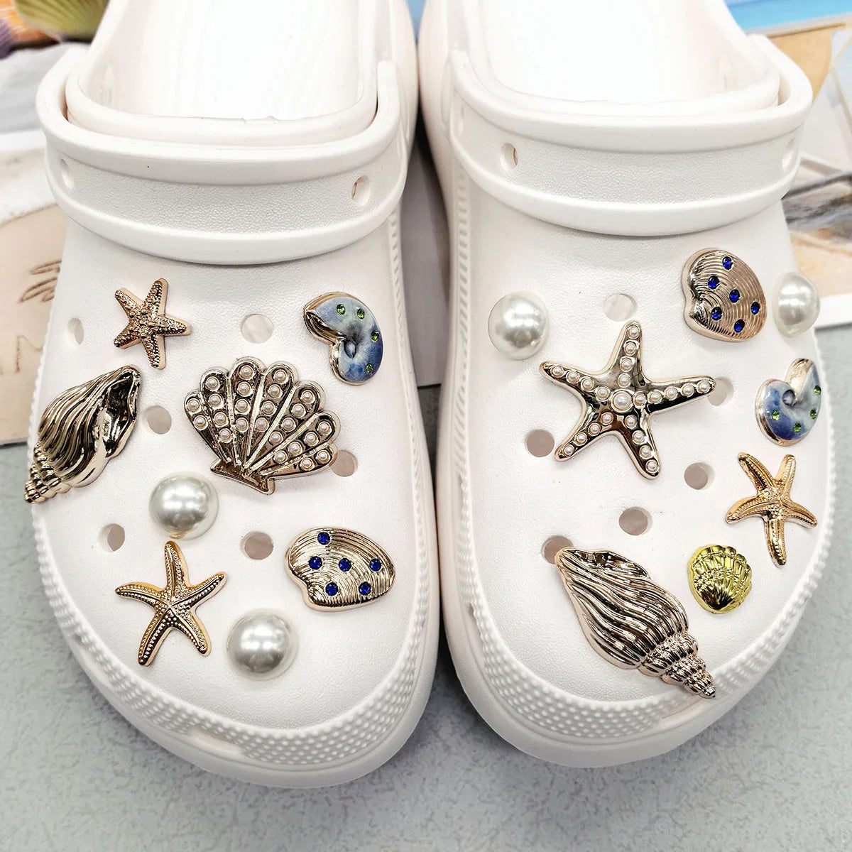 Pair of white shoe charms featuring starfish, shells, and pearls for ocean beach themed footwear
