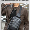 A man wearing a brown leather jacket holds a gray and black geometric pattern crossbody bag.