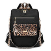 Black fashion backpack with leopard print accents and gold hardware