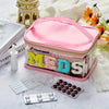 A pink clear embroidered toiletry bag with a lavender lining and various pills and medical supplies displayed on a white surf