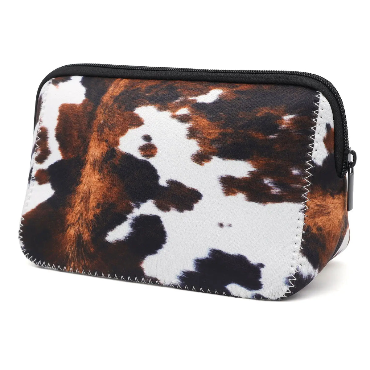 A black and white cow print cosmetic organizer bag with a zippered closure.