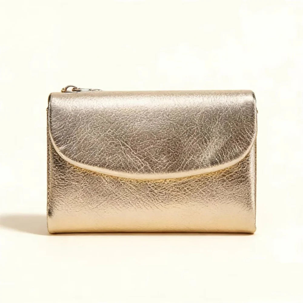 A small, metallic gold leather card holder wallet with a smooth texture, shown against a white background.