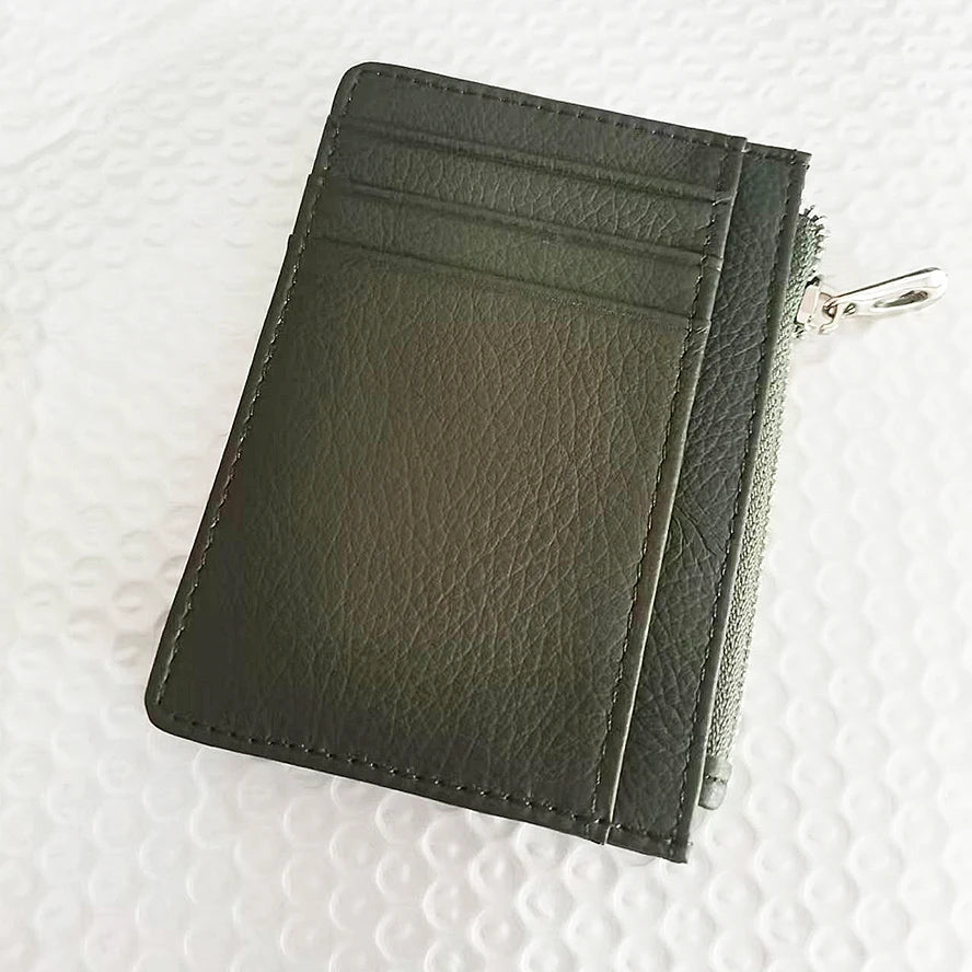 A dark olive green genuine leather zipper card holder and coin purse shown from the side.
