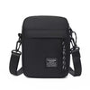 Black minimalist nylon crossbody bag with adjustable strap and leather accents