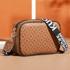 A brown patterned fashion crossbody shoulder bag with black trim and a black strap.
