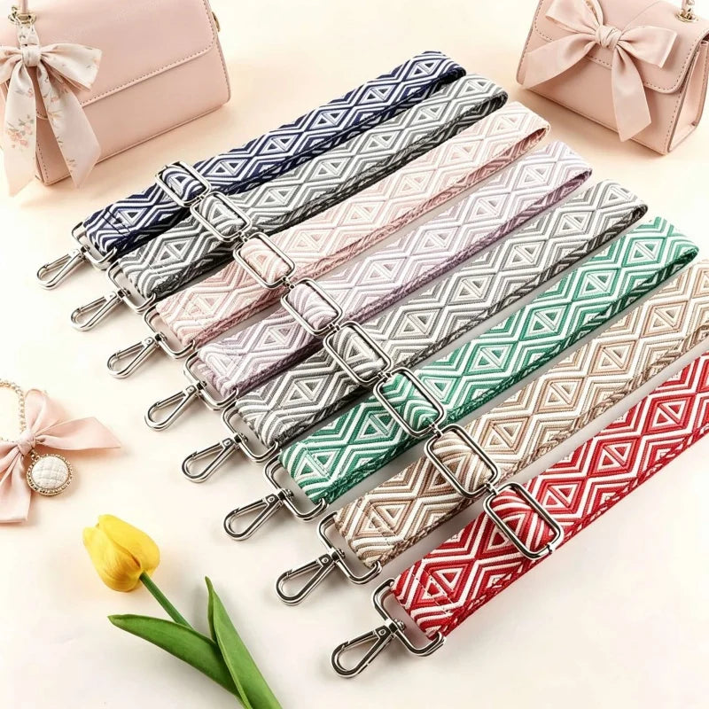 A collection of adjustable nylon shoulder straps in various pastel and geometric patterns for bags and purses.