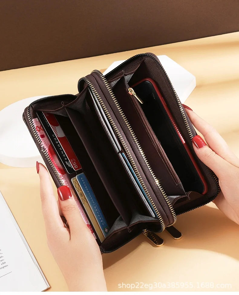 A brown vintage PU leather zippered wallet with multiple compartments is shown open in a hand.