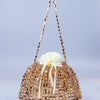A handmade dumpling bag made of gold and silver beads tied with a cream ribbon.