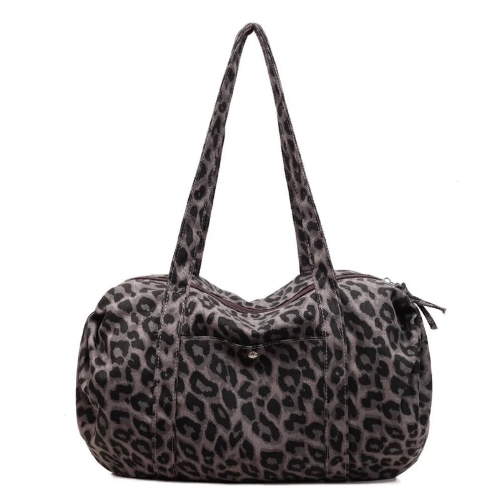 A leopard print canvas tote bag with an adjustable shoulder strap in gray and black patterns.