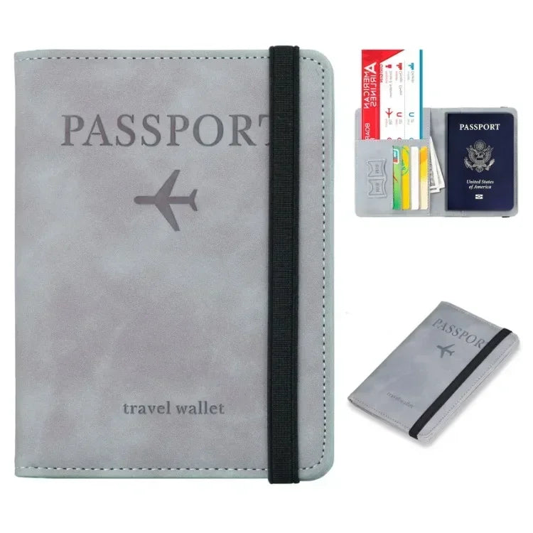 A gray leather passport wallet with a black strap and an airplane design, next to a passport holder.