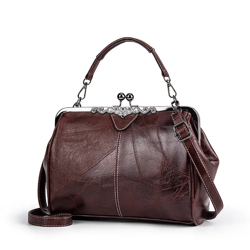 A dark brown leather crossbody shoulder bag with a silver embellishment and leather strap.