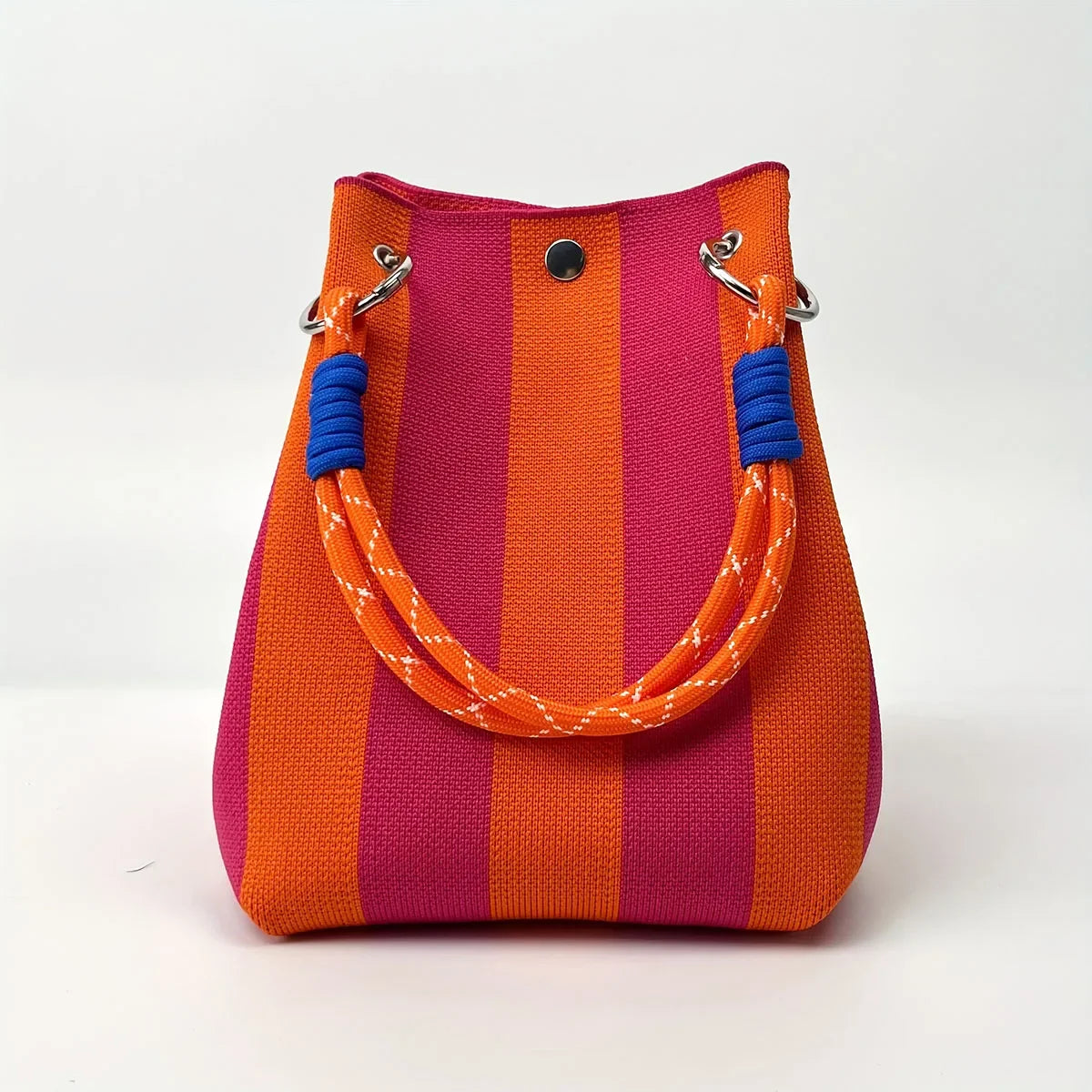 A retro knitted bucket handbag featuring vertical stripes of orange and magenta with blue trim.