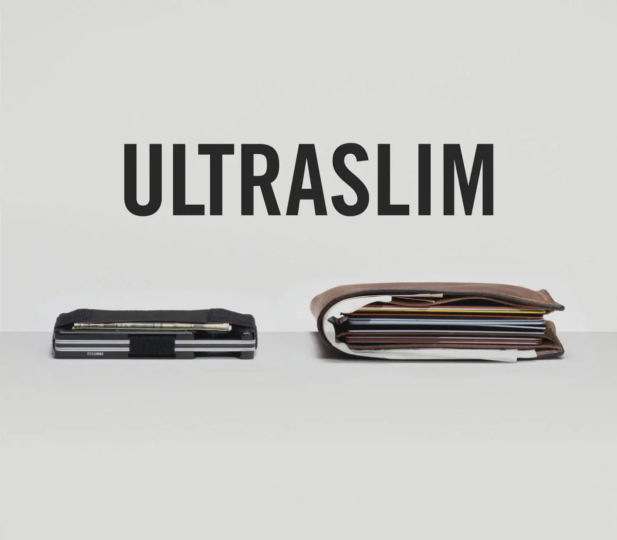 A black slim wallet with a leather strap is displayed on a light gray surface.