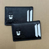 Black leather card holder with a bat design featuring a stylized bat silhouette and vertical cutouts