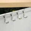 Silver heavy duty hook rack for cabinet doors mounted on a white cabinet frame.