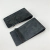 A pair of black carbon fiber money clips, one lying on top of the other.