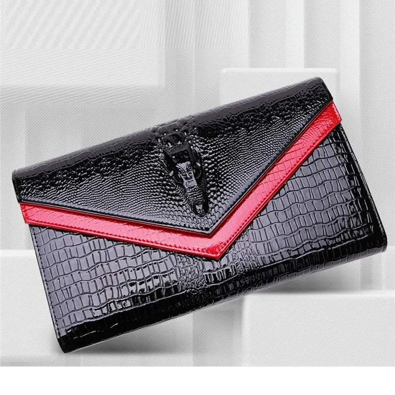 Black alligator pattern leather clutch bag with a red accent edge